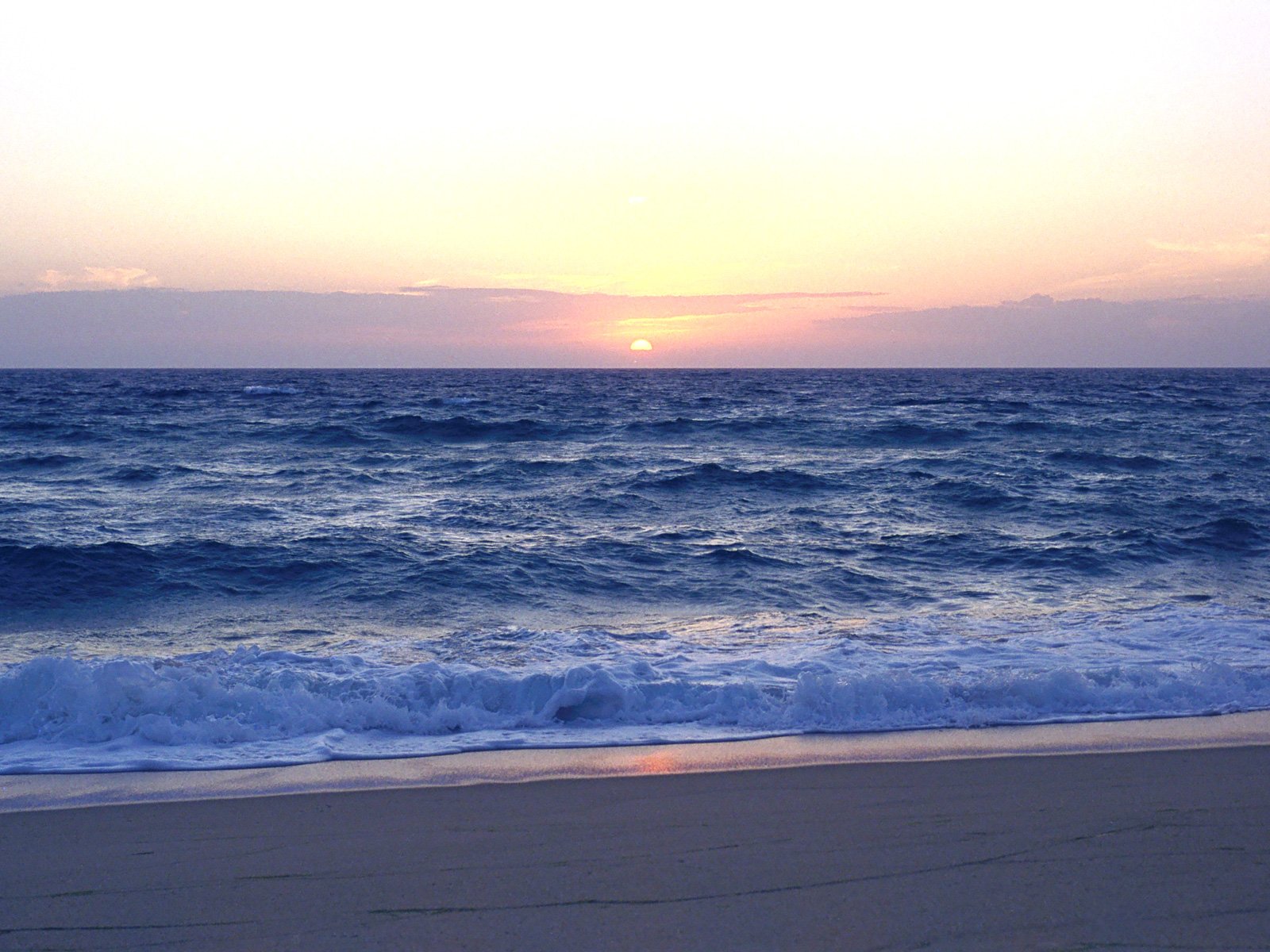 Beach with sunset and waves of the Atlantic Ocean Portugal The coast